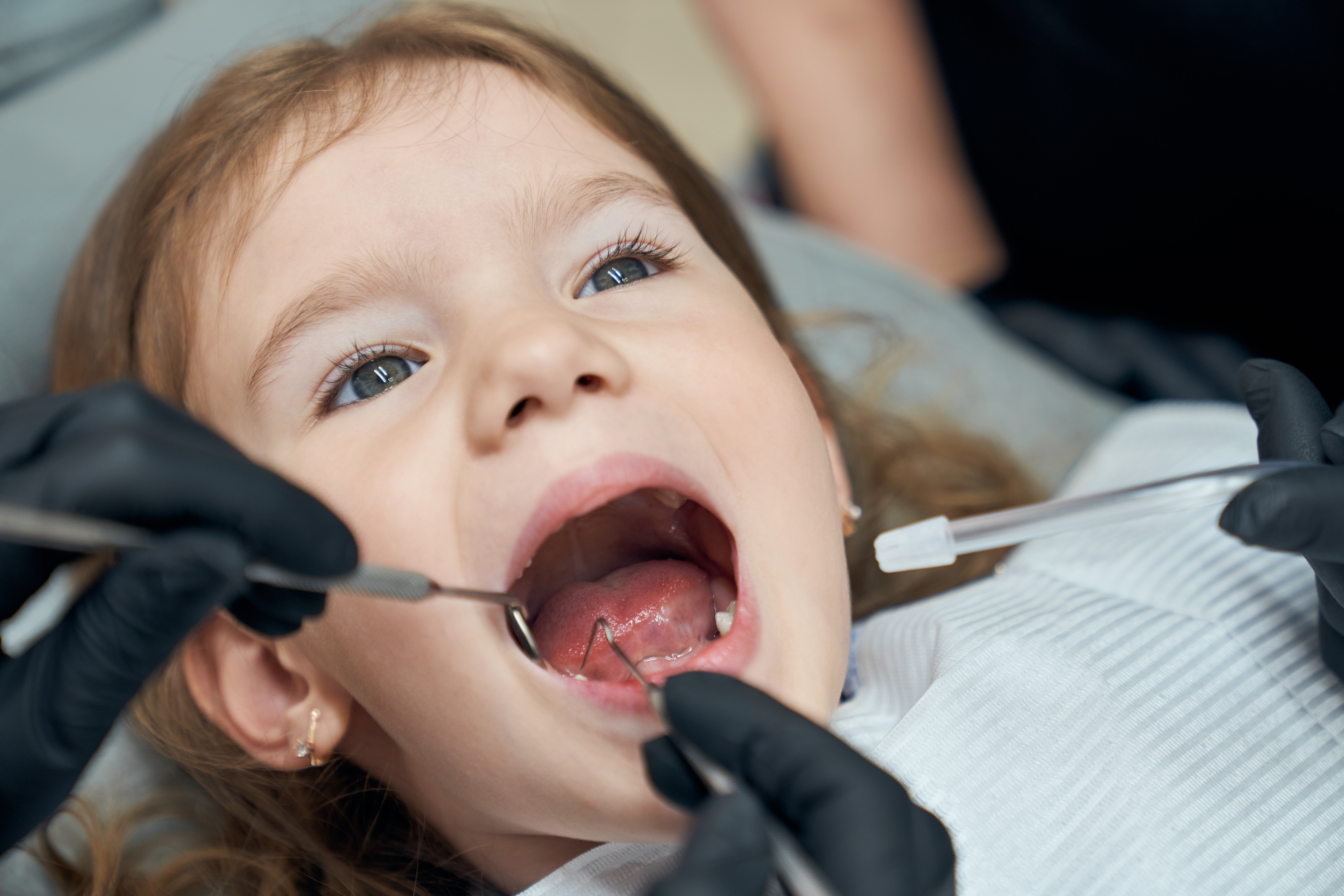 dentist-examining-condition-teeth-little-patient (1)